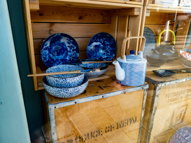 Nepalese crockery display in window of Salzburg store Nepalese crockery display in window of Salzburg store on Getreidegasse, Austria. They are displayed on packing boxes. antique fruit bowl stock pictures, royalty-free photos & images
