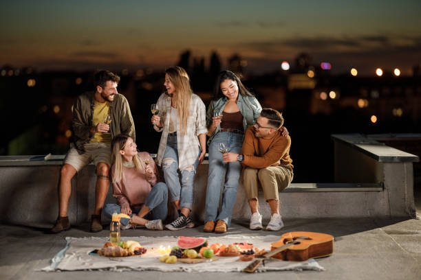 istock Cheerful friends having fun during party night on a roof. 1401327450