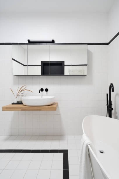 istock Simple black and white bathroom with bathtub 1401328259