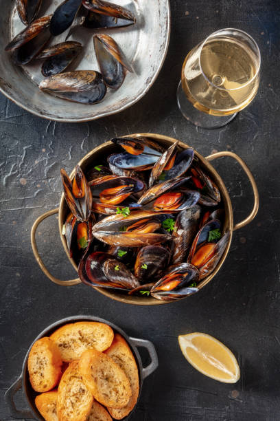 istock Belgian mussels with lemon and toasted bread, with white wine, overhead 1401328419