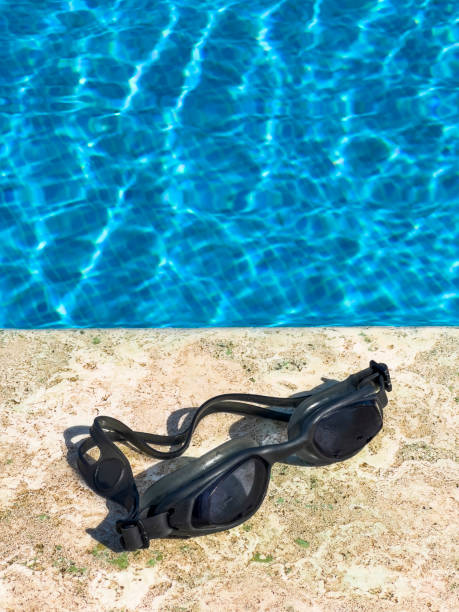 istock Sportive swim goggles at pool edge, high angle view 1401329855
