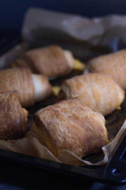 istock Homemade pastry puff buns with cheese on a baking sheet close-up 1401331916