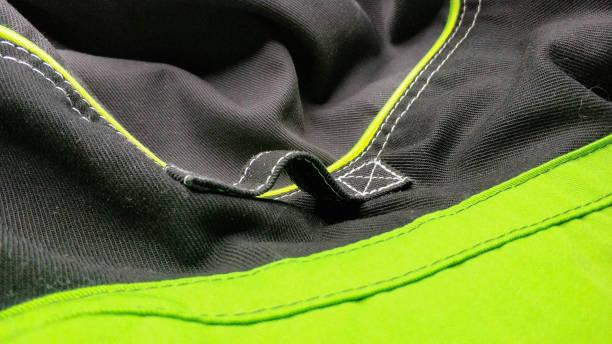 istock Loop on black and green work clothes. workwear close-up seam, screed, texture 1401332014