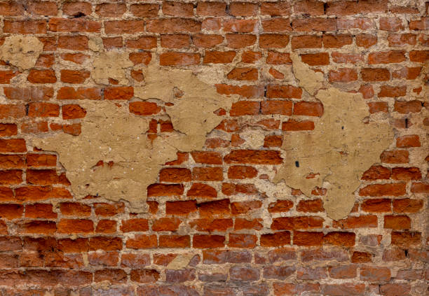 Red obsolete worn out brick wall for background texture or concept.\nCopy space provided.