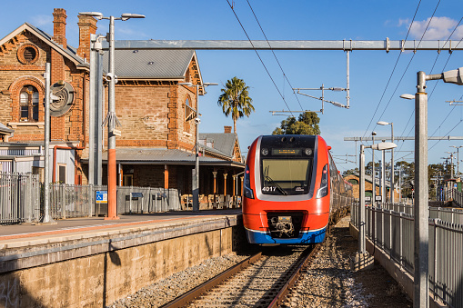 Adelaide, Australia - May 21, 2022: Adelaide Metro electric train on electrified Gawler Line departs Gawler Railway Station bound for Adelaide Railway Station. Test train for new 25kV overhead wiring system and upgraded signalling systems.