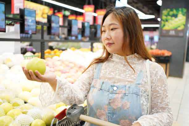 istock A young woman selects fruit in a supermarket 1401339089