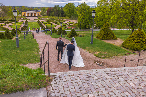 Sweden. Uppsala. 05.14.2022. Beautiful view of wedding couple and guests descending stairs.