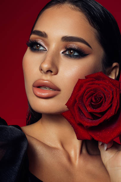 istock Beautiful woman holding red rose 1401341022