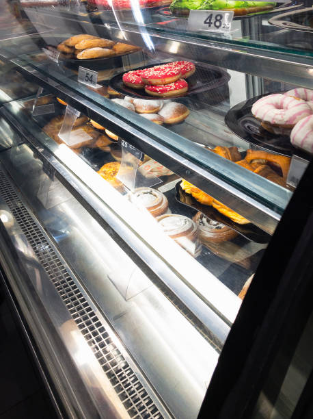 istock cakes and donuts at sale in cafe refrigerated bakery case 1401342050