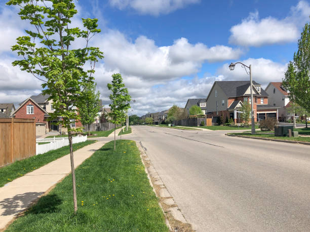 istock Spring city street under blue sky with white clouds 1401342197