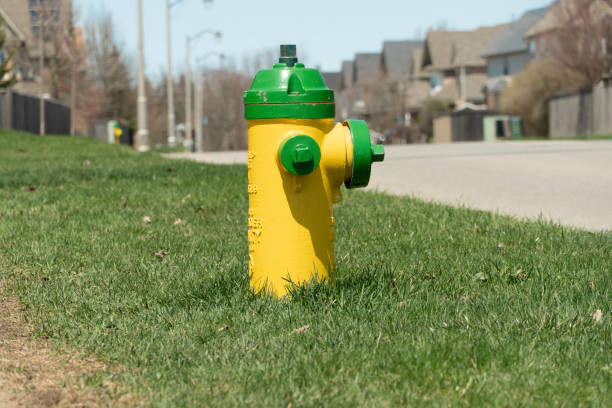 istock Yellow fire hydrant on grass by the roadside on a street 1401342332