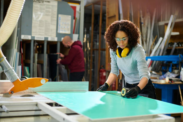 istock female carpenter with colleague 1401343874