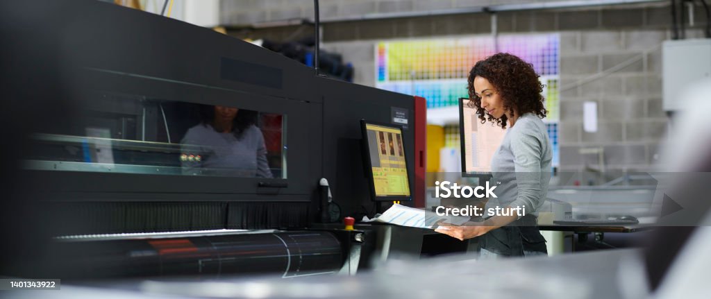 female printing operator Printing Press Stock Photo