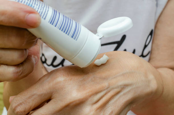 istock Woman applying moisturizer on her hands 1401346106