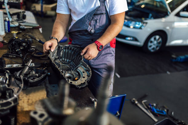 istock Technician working on checking and service car in workshop garage; technician repair and maintenance engine of automobile in car service 1401347179