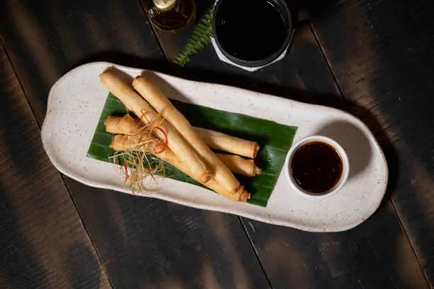Lumpia are various types of spring rolls commonly found in the Philippines and Indonesia. Lumpia are made of thin paper-like or crepe-like pastry skin called "lumpia wrapper" enveloping savory or sweet fillings.