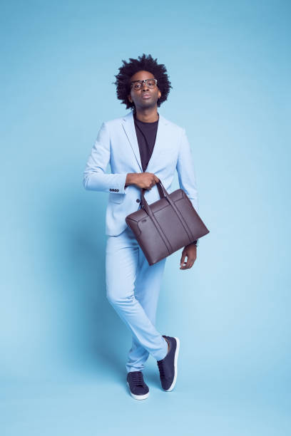 istock Businessman with briefcase against blue background 1401348372