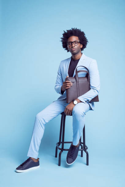 istock Confident businessman with briefcase on stool 1401348441