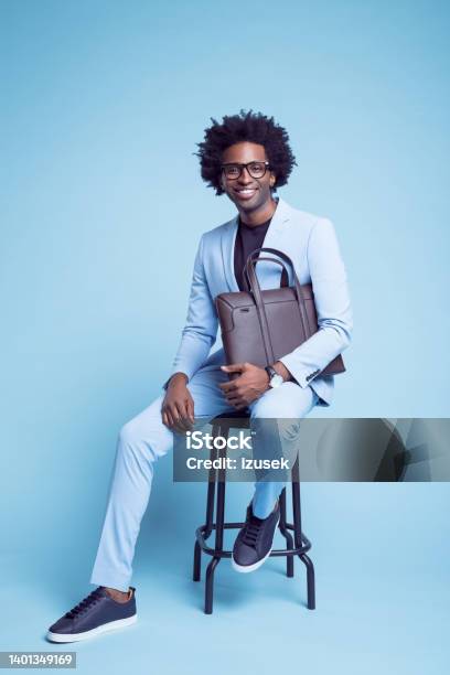 Man With Briefcase Sitting On Stool Stock Photo - Download Image Now - Men, Sitting, Fashion