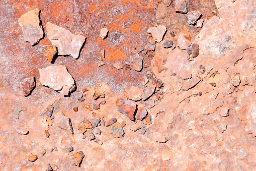 Detail shot from a higher angle of a  large pile of crushed stone and earth for commercial use and blue sky