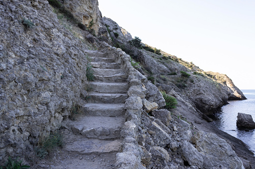 an old stone staircase in the mountains near the sea