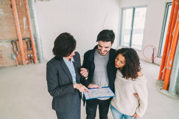 istock Real estate agent showing new home to clients 1401350580