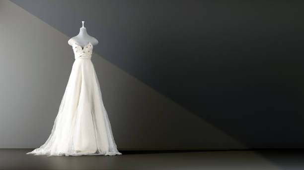 abito da sposa in un fascio di luce su sfondo nero - abito da sposa foto e immagini stock