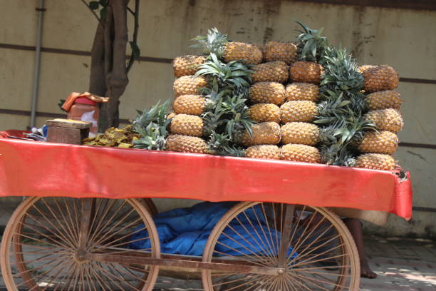 istock Fresh pineapples kept for sale in a small vehicle that is powered by hand 1401351823