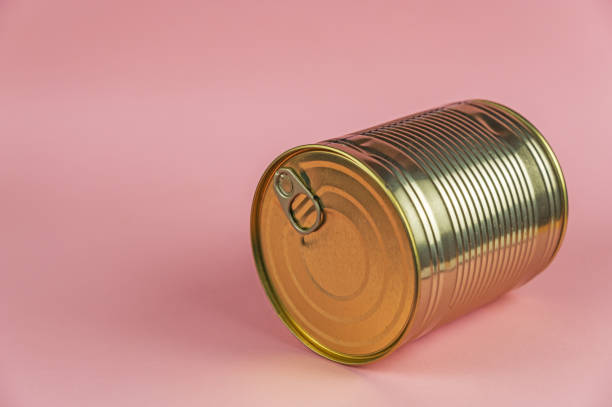 istock Canned Food. A gold can against a pink background. Selective focus. 1401352403