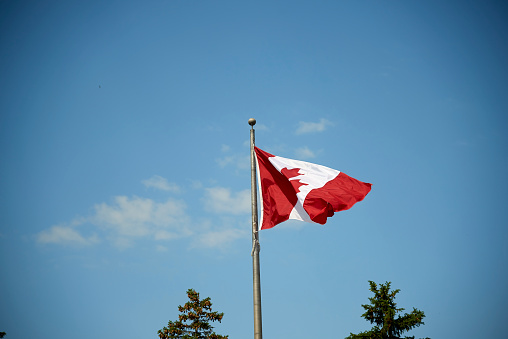A Canadian flag on a boat over the water in coastal British Columbia