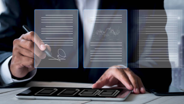 istock businessman use electronic pen sign signature on electronic  E-signing, data sheet document management, paperless office concept. Businessman using stylus pen signing e document on digital tablet. 1401355726
