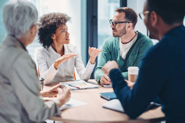 istock Black businesswoman talking to her team 1401358520