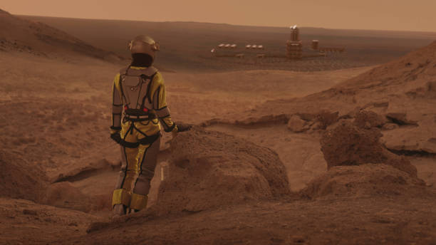 istock Astronaut on planet Mars watching a space station. Earth colony in Space 1401359424