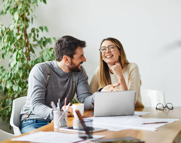 young business people meeting office teamwork happy man woman  businessman start up fun couple love Portrait of young business people having a meeting in the office, having fun together and laughing work romance stock pictures, royalty-free photos & images