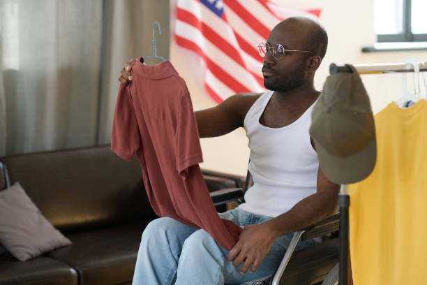 istock Man with disability choosing clothes for day 1401361339