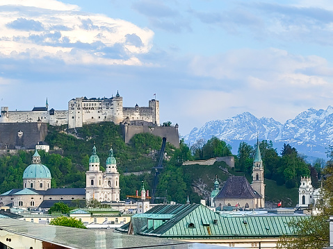 Salzburg, Austria - May 22, 2017: Hohensalzburg fortress on top of Festungsberg mountain, and church towers of Salzburg Old Town. View from observation point at Monchsberg mountain.