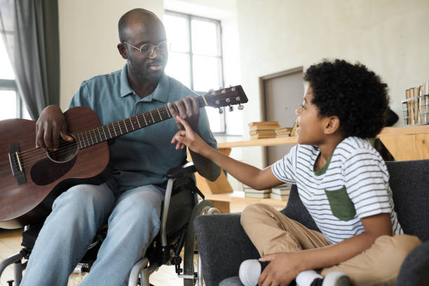 istock Dad learning his son to play guitar 1401362614