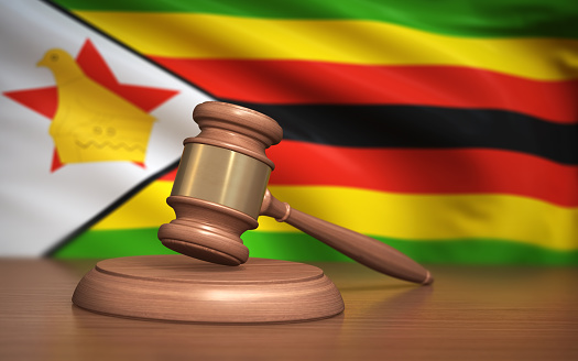 3d Render Judge Gavel and Zimbabwe flag on background (Depth Of Field)