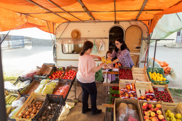 Female owners working with fruit and vegetables on the market
