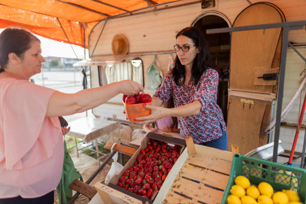 istock Young business woman selling fresh tomatoes 1401364874