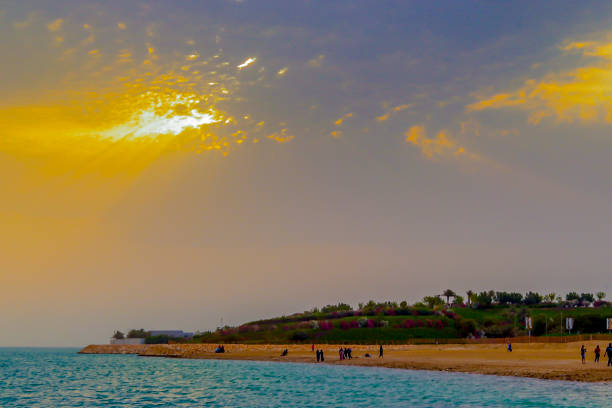 Just done from a photoshoot for a person then I was walking around salman city which were created and built in bahrain not long time ago and I saw this sunrise with big clouds, the sun was behind the clouds but the flares were showing