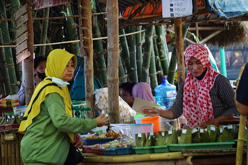 People buy food on Pasar ndeso Sor Preng Mojo. Pasar ndeso means a traditional market that sells Indonesian traditional snacks and food