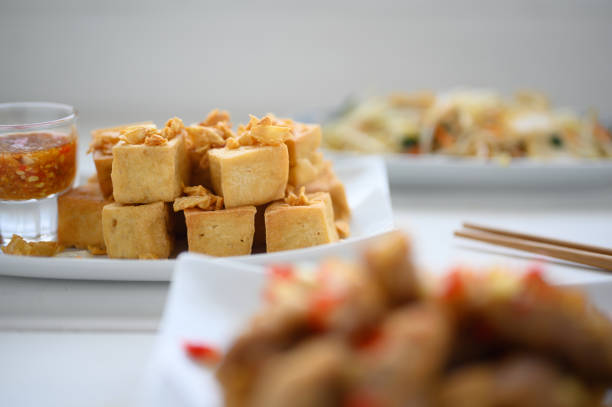 Deep fried tofu is cut into square balls on plate , asian food