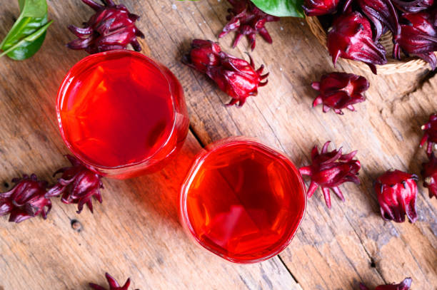 Roselle juice on wooden background, herbal organic tea for good healthy stock photo