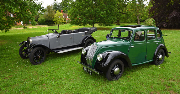 Ickwell, Bedfordshire, England - June 06, 2021:  Vintage Morris 8 and Austin Motor Cars parked on Ickwell Village Green.
