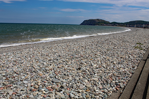 A landscape shot from Llandudno Beach in North Wales. A mountain can be seen in the background.