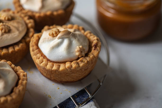 istock Lemon curd tartlets with whipped meringue and caramel sauce. 1401375876