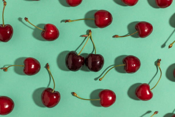 istock Sweet red cherries on a turquoise background. 1401375888