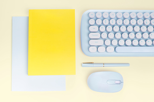 flat lay yellow book and blue stationery on yellow  background