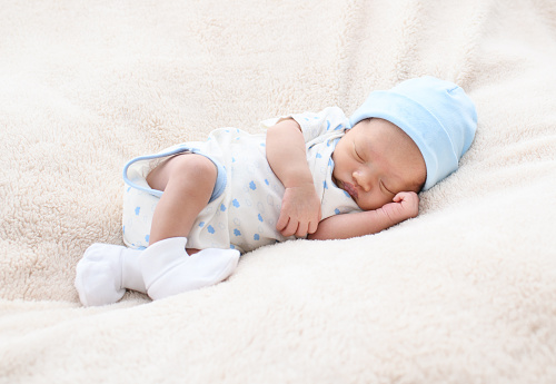 Newborn asian baby girl sleep on white bed relaxing feelgood happy. people health care concept.